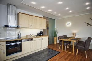a kitchen with a table and a dining room at hafennahe Ferienwohnung mit Meerblick - Hafenresidenz Lauterbach FeWo 2-3 in Lauterbach