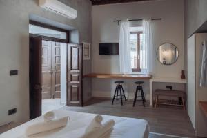 a bedroom with a bed and a kitchen with a counter at Kilistra Lindian Living in Lindos