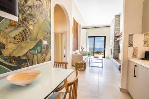 a kitchen and dining room with a large painting on the wall at Euphoria Suites in Karpathos Town