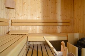 a wooden sauna with a wooden bench in it at Hotel Cafe Fuggerhof in Oberstdorf
