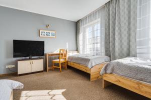 Posteľ alebo postele v izbe v ubytovaní Hotel Sowa