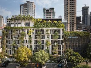 an office building with trees on top of it at Baitong Hotel & Resort Phnom Penh in Phnom Penh