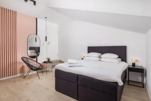 a bedroom with a large bed and a chair at Apartment Pearl, Opatija center in Opatija