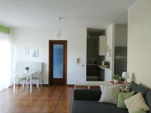 a living room and kitchen with a couch and a table at Casetta con terrazza in Como