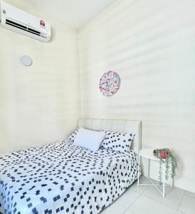 a small bedroom with a bed and a air conditioner at Homestay Akasia 12 in Seri Iskandar