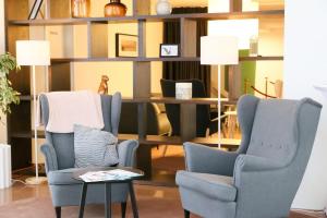 a living room with two chairs and a table at LUXURY APARTMENT VBLOKU in Prague