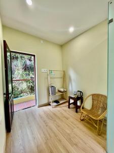 a living room with a chair and a window at Haven Vietnam in Quy Nhon