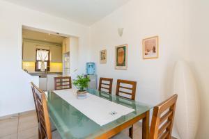 a dining room with a glass table and chairs at Villa Vista Mare in Kalkan