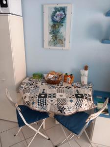 a table with a quilt on it in a kitchen at Petit avec classe Sanremo in Sanremo