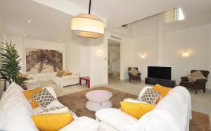 a living room with white couches and a tv at Colonia Sea Holiday in Colonia Sant Jordi