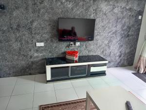 a living room with a flat screen tv on a wall at Cameron Highlands Homestay in Tanah Rata