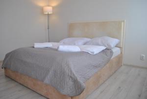 a bedroom with a large bed with two pillows at Warsaw Apartments Werset in Warsaw