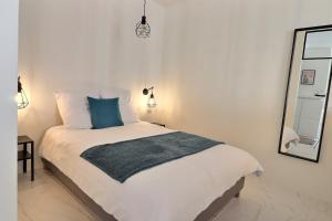 a bedroom with a bed with a blue pillow and a mirror at P&R1, one bedroom, city center Geneva in Geneva