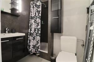 a bathroom with a toilet and a shower curtain at P&R1, one bedroom, city center Geneva in Geneva +6 photos