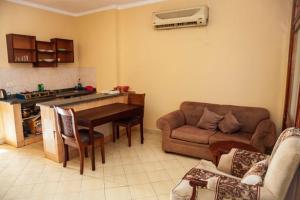 a living room with a couch and a table in a kitchen at Apartment Sharm in Sharm El Sheikh