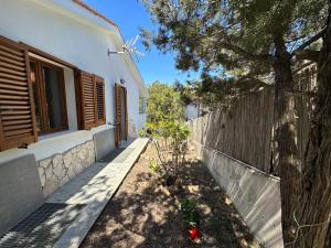 una casa con una valla y un árbol en Villa Ludi en Maladroscia