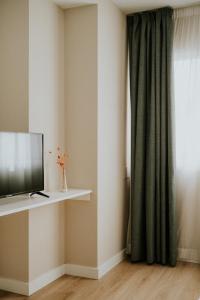 a television sitting on a shelf next to a window at Mares - Coral in Torre del Mar