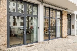 a group of glass doors on a building at Stylish New Cube Loft II by Berlin-Wall-Apartments in Berlin
