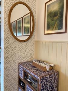 a mirror on a wall with a table in a room at Franz Josef am Ratschenberg in Eisenberg an der Pinka