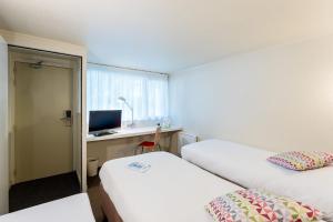 Postel nebo postele na pokoji v ubytování Campanile Rouen Sud - Zénith - Parc Expo