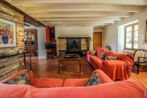 a living room with orange couches and a fireplace at MAISON DE CHARME - 250m2 - CALME - JARDIN in Florentin