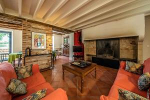 a living room with orange furniture and a fireplace at MAISON DE CHARME - 250m2 - CALME - JARDIN in Florentin