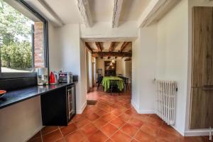 a kitchen with a counter and a table in a room at MAISON DE CHARME - 250m2 - CALME - JARDIN in Florentin +51 photos