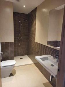 a bathroom with a toilet and a sink and a shower at Roses Casc Antic S L Sabater 1 in Roses