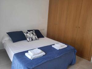 a bedroom with a bed with two towels on it at Roses Casc Antic S L Sabater 1 in Roses