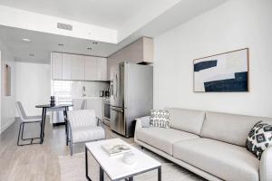 a living room with a couch and a kitchen at Downtown 1BR w Pool Jacuzzi Gym nr 110 LAX-836 in Los Angeles