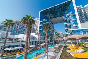 a pool at the resort with palm trees and hotels at Daniels 2BR Five Palm Breathtaking view in Dubai