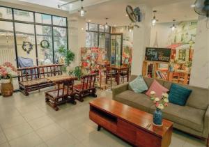 a living room with a couch and a coffee table at Galaxy Boutique Sai Gon Hotel - by Bay Luxury in Ho Chi Minh City