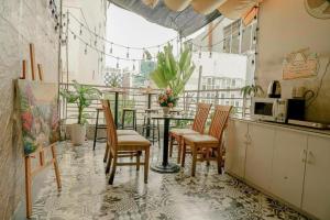 a kitchen with chairs and a table on a balcony at Galaxy Boutique Sai Gon Hotel - by Bay Luxury in Ho Chi Minh City