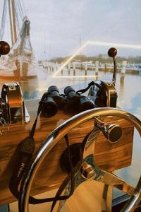 a pair of binoculars sitting on top of a table at Hausboot mit Traumlage in Travemünde in Rönnau