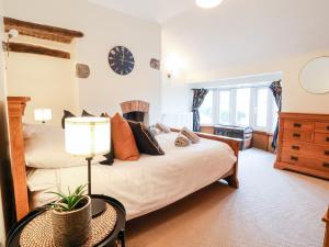 a bedroom with a bed and a clock on the wall at Riverdale in Rhyl
