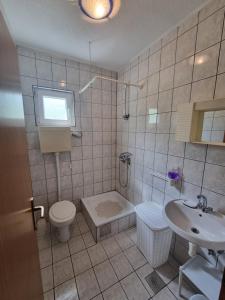 a bathroom with a toilet and a sink at Međugorje Apartman Jurković in Donja Mahala