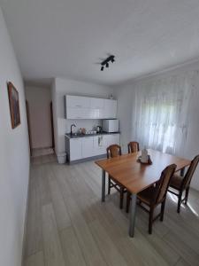 a kitchen and dining room with a table and chairs at Međugorje Apartman Jurković in Donja Mahala