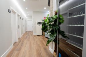 a hallway with white walls and wooden floors at Center Suite Acebedos in Santander