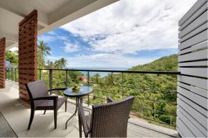 a balcony with a table and chairs and a view at Scenery Sunrise in Chaweng Noi Beach