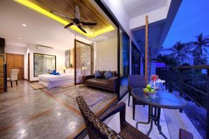 a living room with a bed and a table at Scenery Sunrise in Chaweng Noi Beach