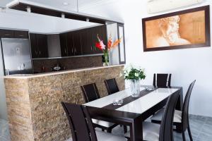 a dining room with a black table and black chairs at Sorocada Private House in Akrotiri
