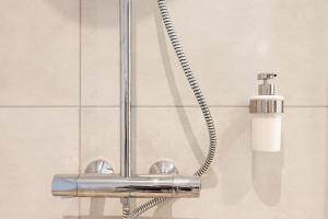 a bathroom sink with a chrome shower head at Bliss - Résidence Hestia in Saint-Étienne
