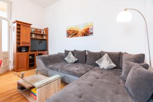a living room with a couch and a tv at Pier 1 in Heringsdorf