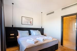 a bedroom with a bed with two towels on it at Miramare Hotel in Zadar