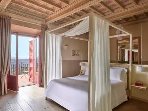 A bed or beds in a room at Tenuta di Artimino member of Meliá Collection Wine Resort