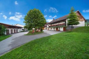 an empty road leading to a building with a tree at Winzerhof Wörner in Durbach