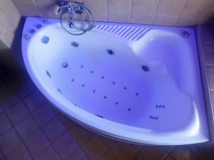 a large white bath tub in a bathroom at Attic Paradise in Flogita