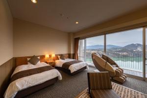 Giường trong phòng chung tại Enakyo Onsen Hotel Yuzuriha