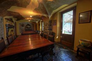 a dining room with a large wooden table and a window at Locanda La Pergola in Bellagio