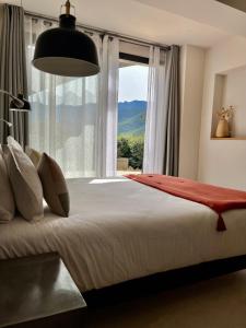 a bedroom with a large bed with a large window at CASA IB in Peri +68 photos